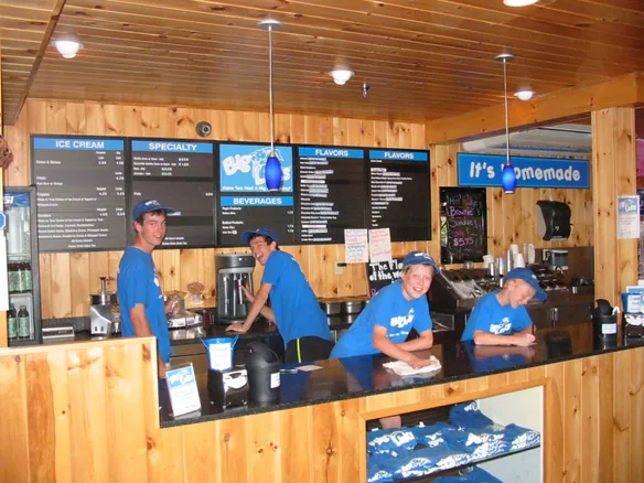 The four boys working the Big Licks counter under the menu boards