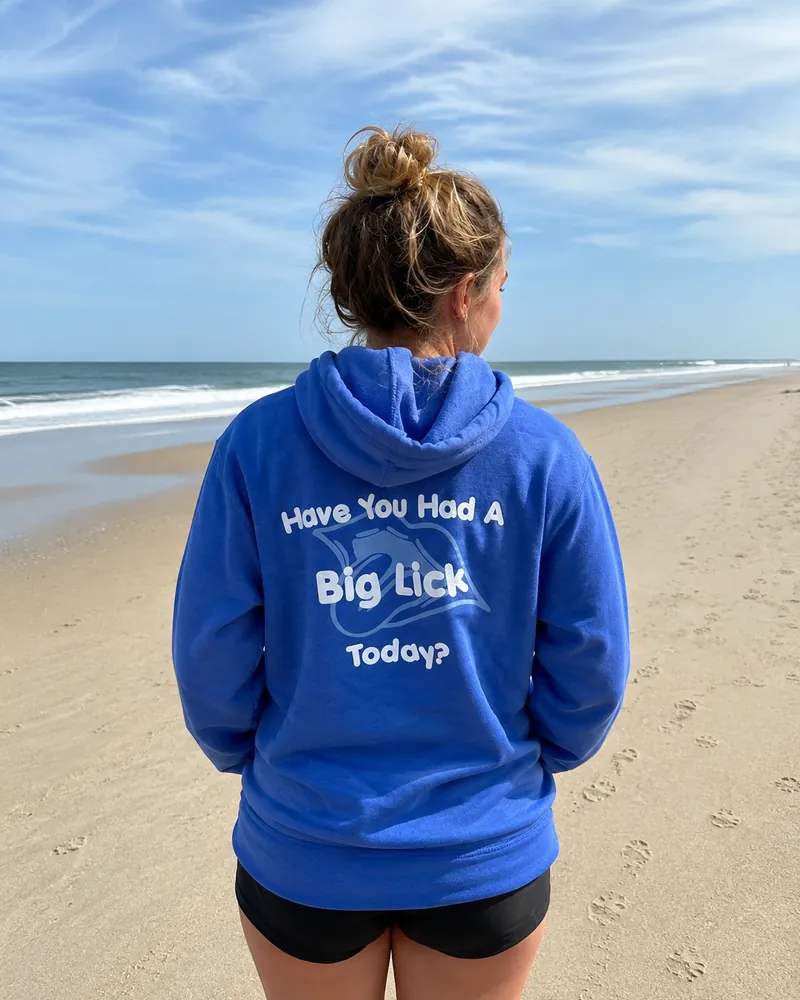 The back of the Big Licks hooded sweatshirt on a woman, reading Have You Had A Big Lick Today?